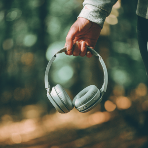 person holding headphones